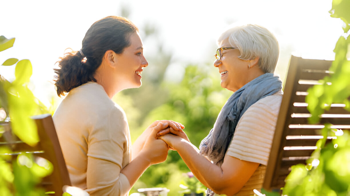 Caregiver spending quality time with senior resident outdoors