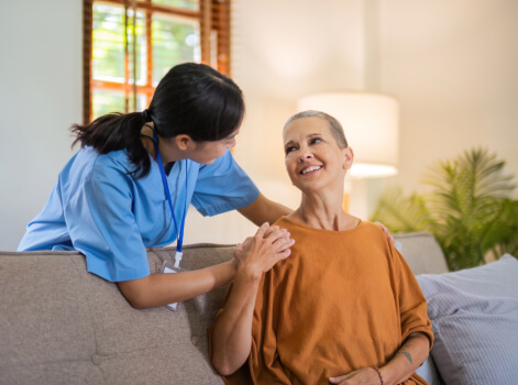 Healthcare worker assisting elderly woman with personal care