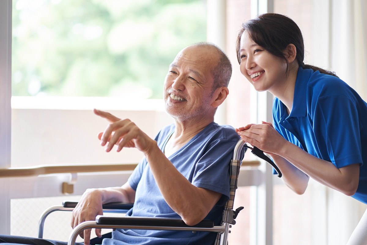 Caregiver assisting senior with mobility and daily activities