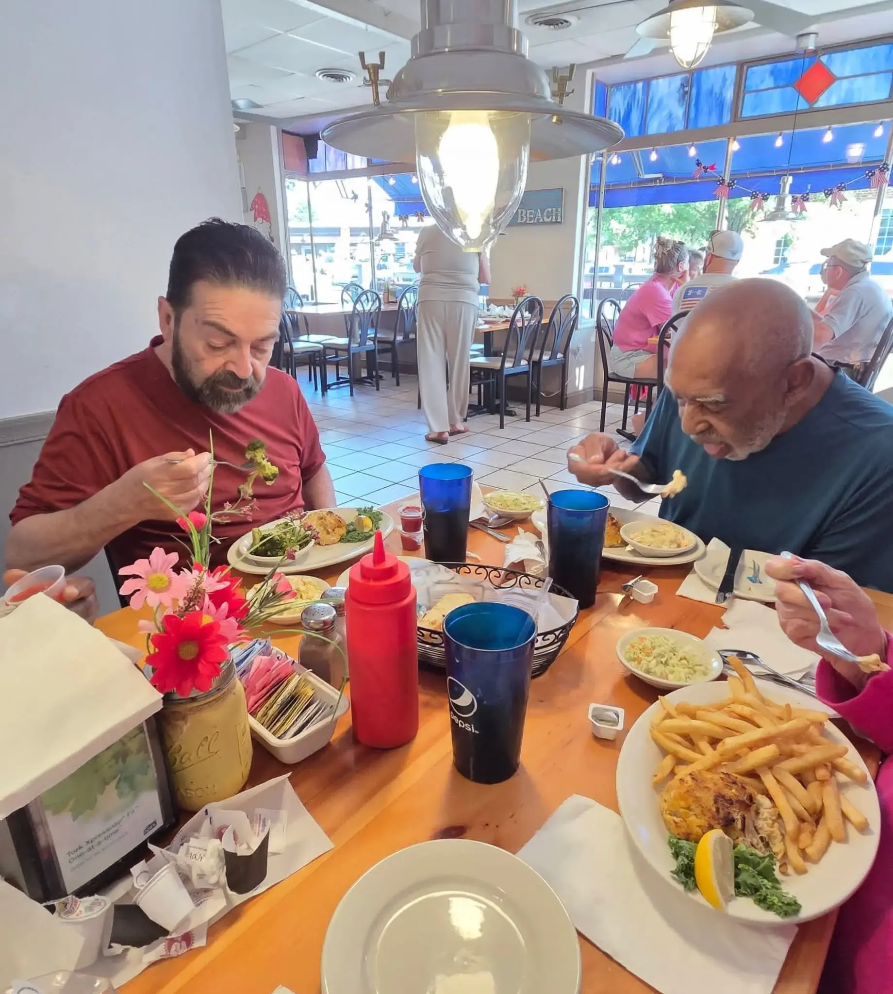 Residents having a meal together at a community restaurant outing