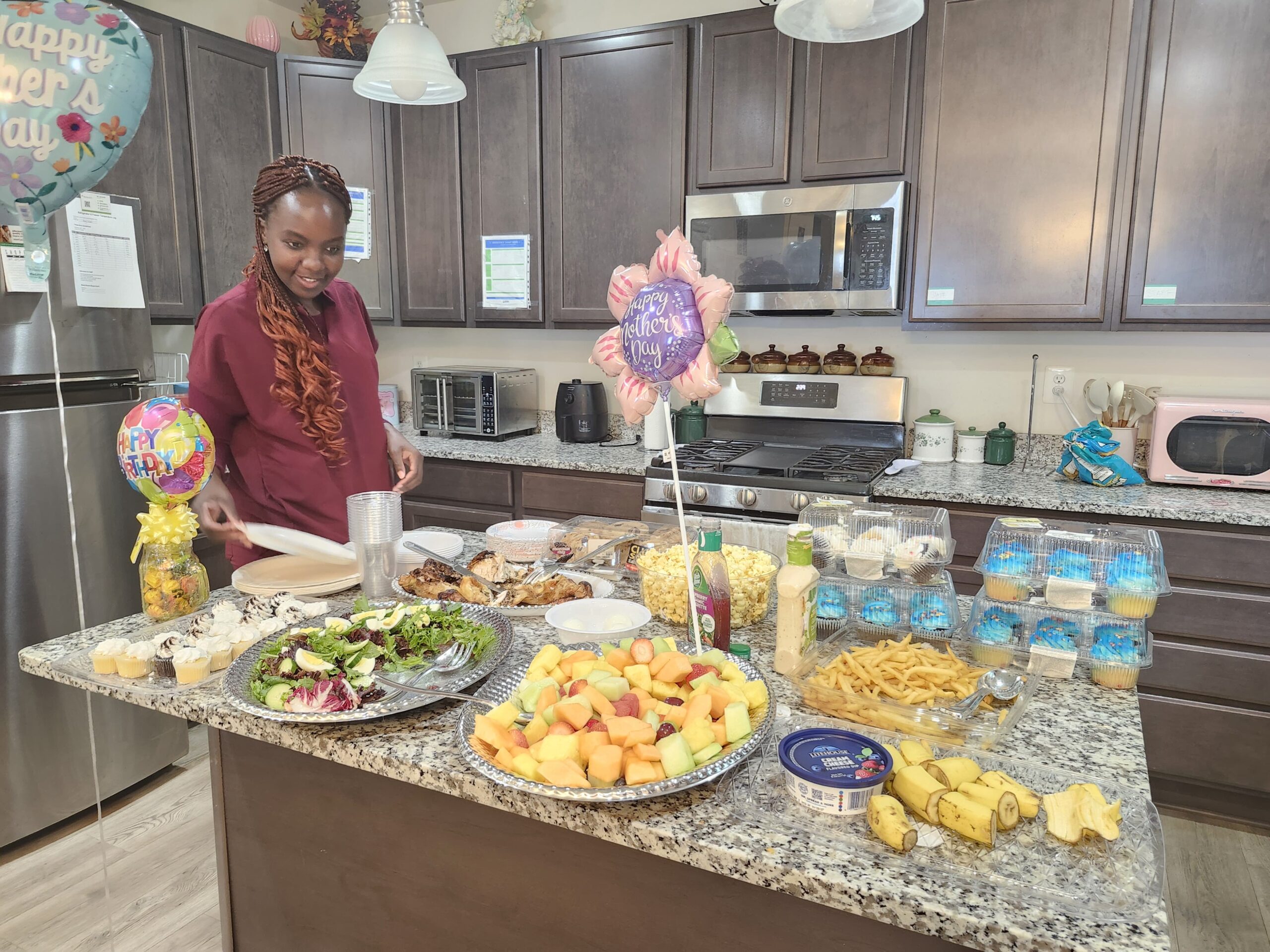 Caregiver preparing food for residents in assisted living kitchen