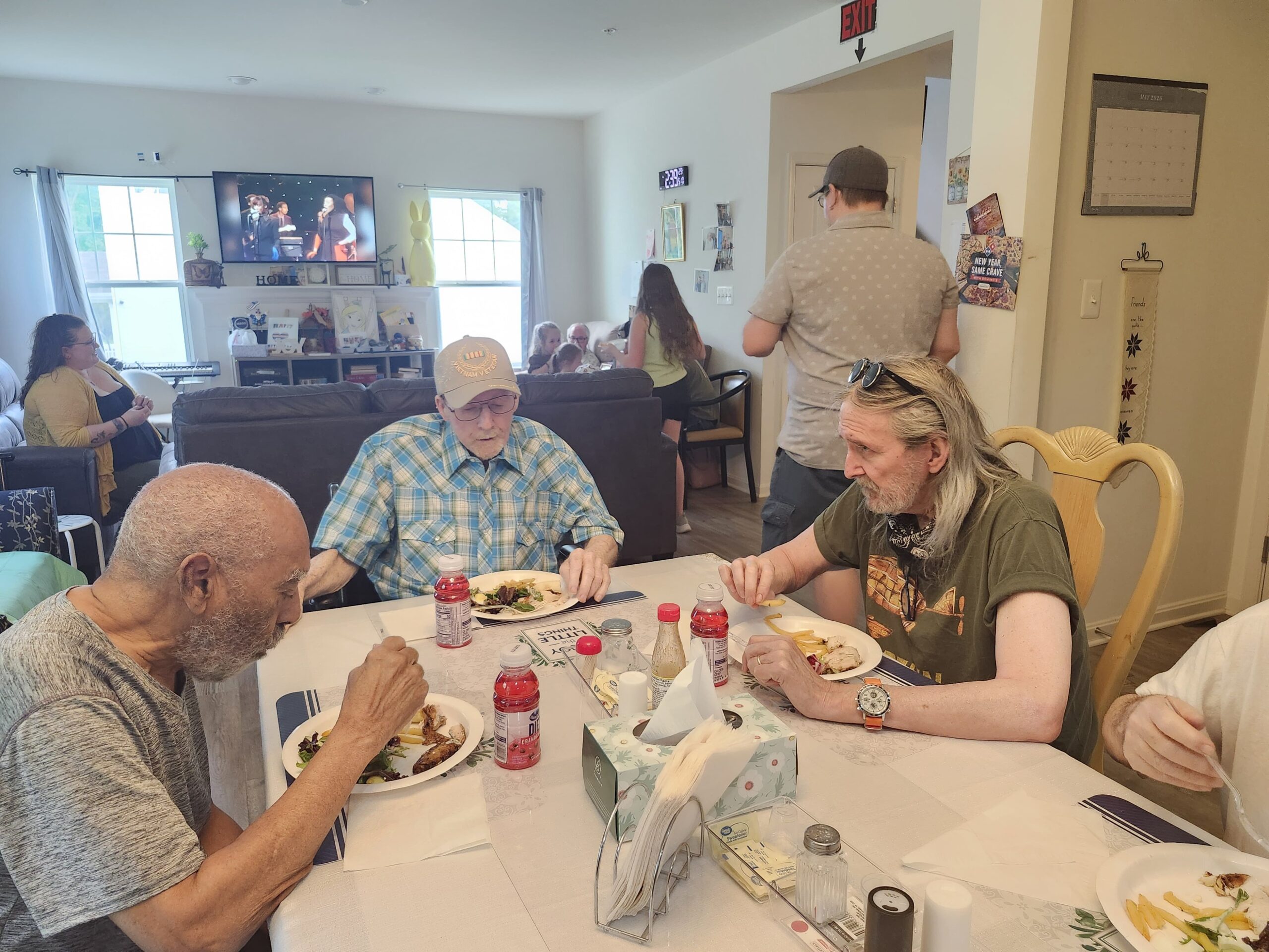 Residents enjoying a meal together in assisted living dining area