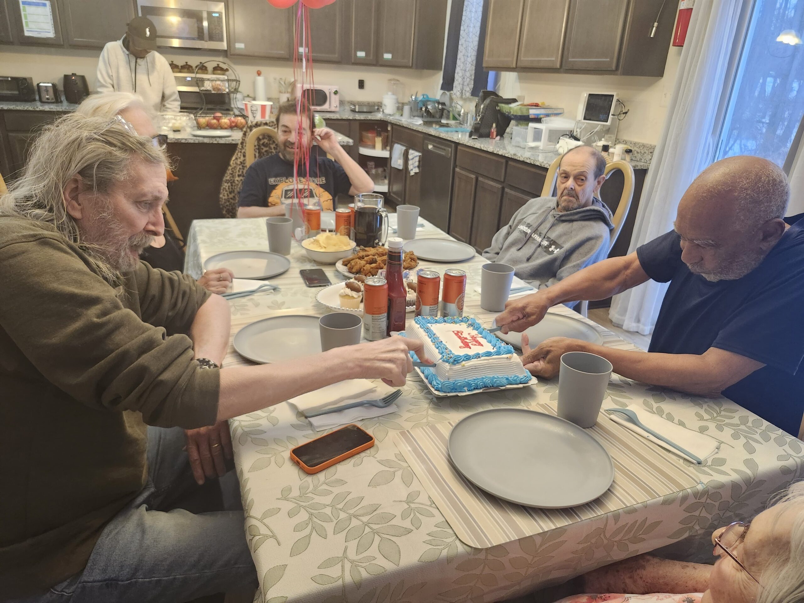 Residents celebrating a special occasion during assisted living community gathering