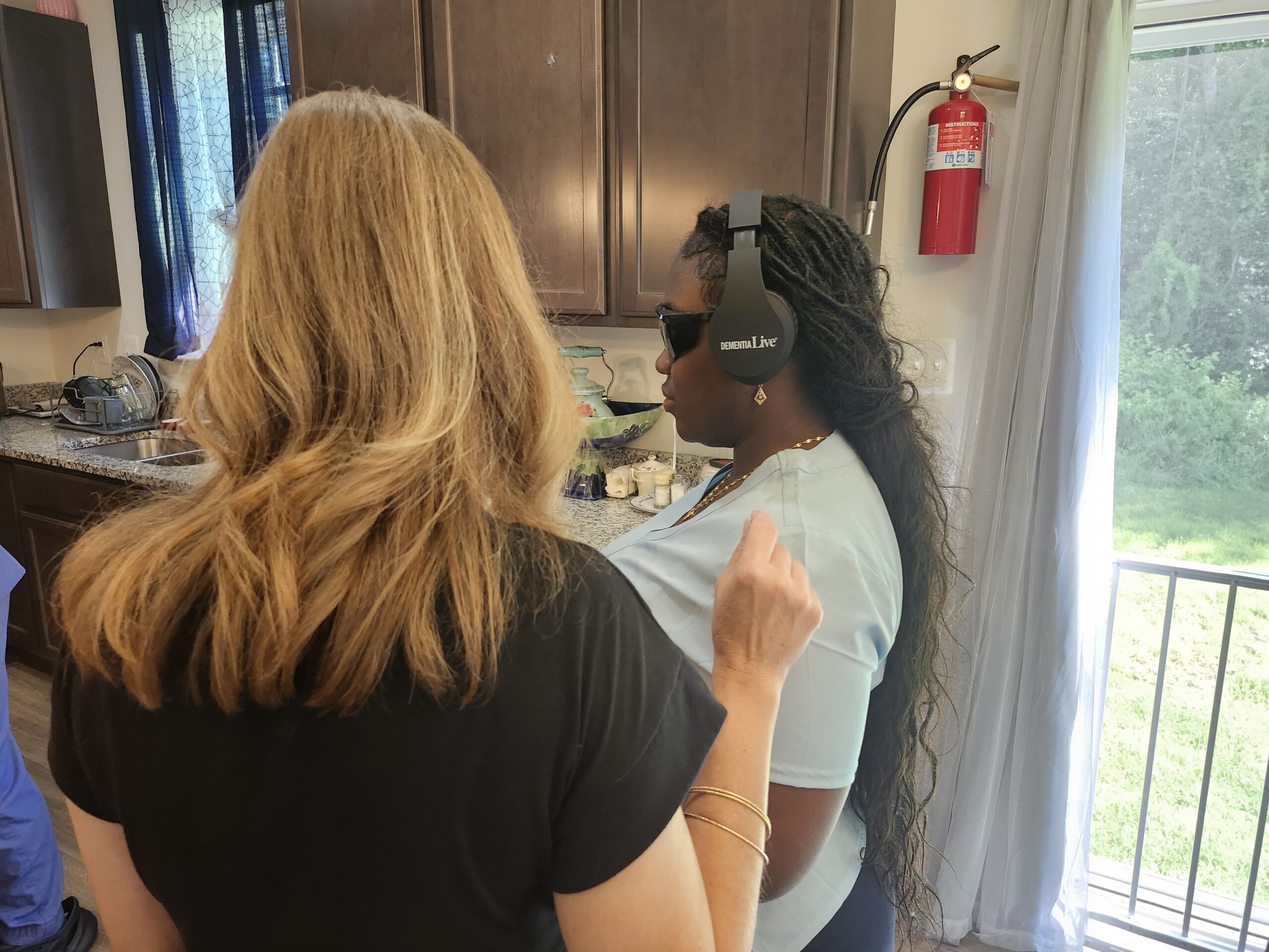 Caregiver providing support and assistance to resident indoors