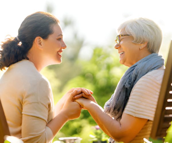 Caregiver spending quality time with senior resident outdoors