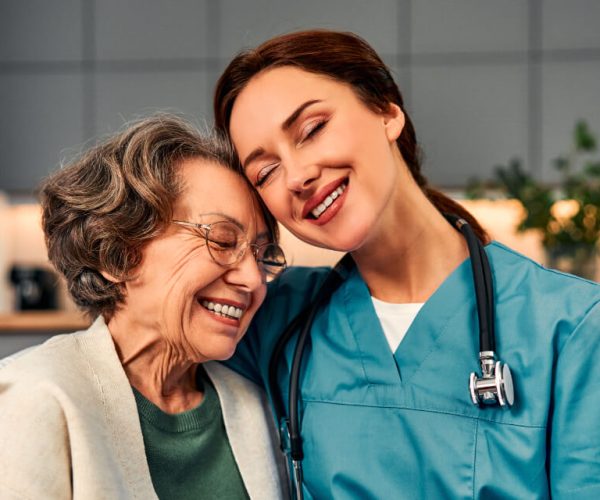 Senior caregiver offering companionship and assistance to elderly woman